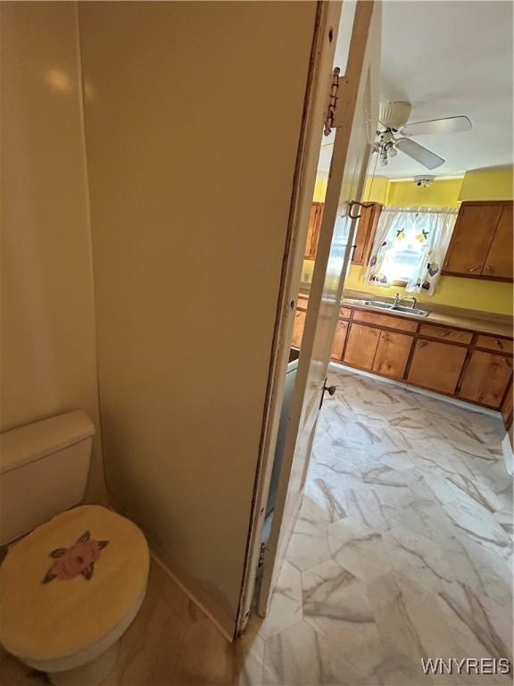 83 Felton St, North Tonawanda, NY 14120 - bathroom with vanity, marble look tiles, and ceiling fan