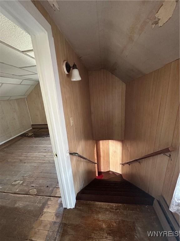83 Felton St, North Tonawanda, NY 14120 - staircase featuring wood walls, lofted ceiling, and hardwood / wood-style floors