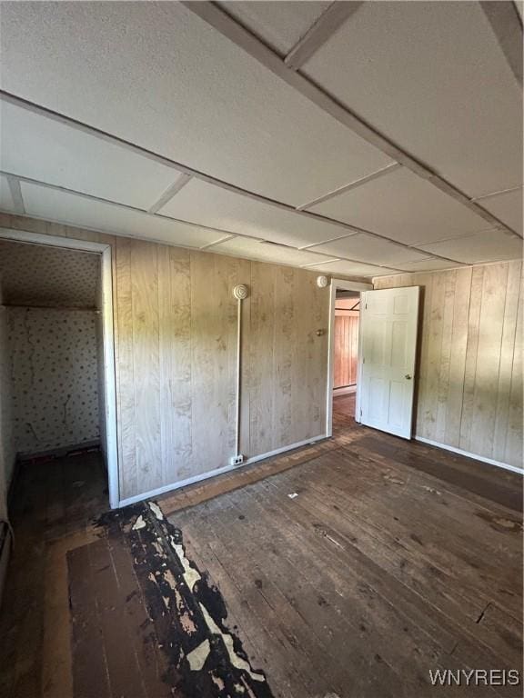 83 Felton St, North Tonawanda, NY 14120 - unfurnished bedroom with hardwood / wood-style flooring and wood walls