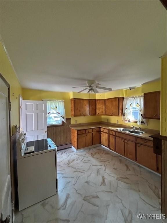 83 Felton St, North Tonawanda, NY 14120 - kitchen with brown cabinets, a baseboard radiator, a ceiling fan, and light marble finish flooring