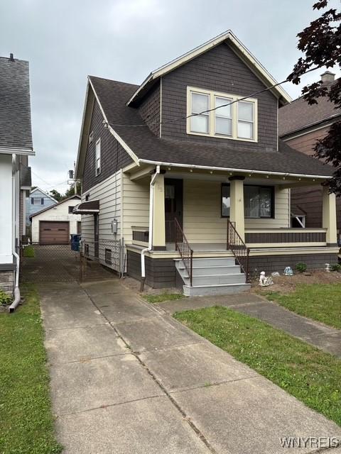 93 Mariemont Ave, Buffalo, NY 14220 - view of front of house featuring a porch, an outdoor structure, a shingled roof, and a garage