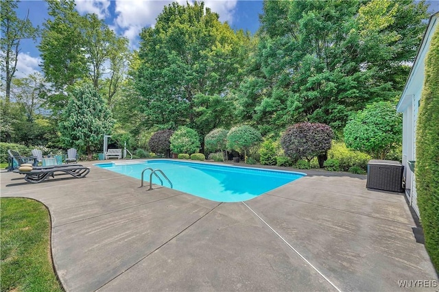 57 Middlebury Rd, Orchard Park, NY 14127 - swimming pool featuring a patio area and view of wooded area