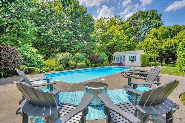 57 Middlebury Rd, Orchard Park, NY 14127 - outdoor pool with an outdoor structure, view of wooded area, an exterior structure, and a wooden deck