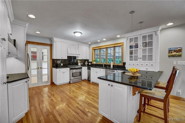 57 Middlebury Rd, Orchard Park, NY 14127 - kitchen featuring stainless steel appliances, custom exhaust hood, white cabinets, light wood finished floors, and recessed lighting