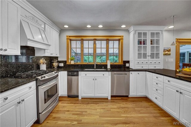 57 Middlebury Rd, Orchard Park, NY 14127 - kitchen with stainless steel appliances, custom range hood, white cabinetry, healthy amount of natural light, and recessed lighting