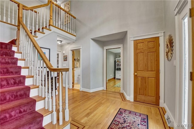 57 Middlebury Rd, Orchard Park, NY 14127 - entrance foyer featuring wood finished floors, a towering ceiling, and stairs