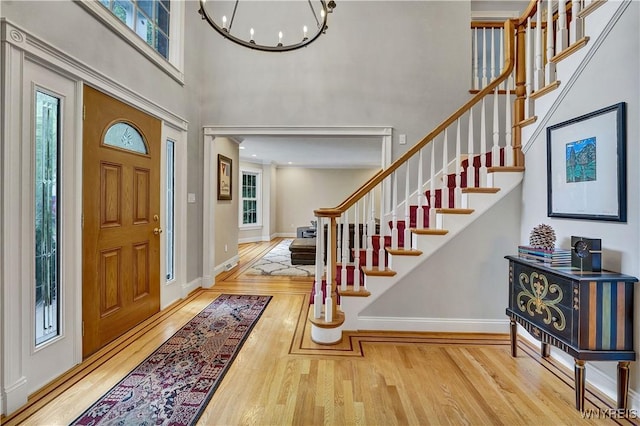 57 Middlebury Rd, Orchard Park, NY 14127 - foyer with a towering ceiling, wood finished floors, stairs, and a chandelier