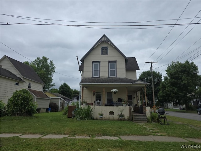 1025 Spruce St, Olean, NY 14760 - victorian home featuring covered porch, a front yard, and roof with shingles