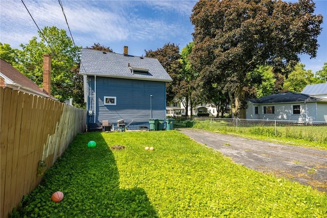 147 Springfield Ave, Rochester, NY 14609 - view of side of home featuring a chimney and a shingled roof