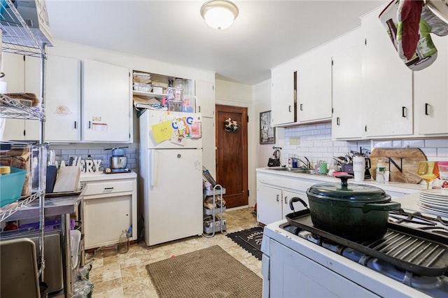 147 Springfield Ave, Rochester, NY 14609 - kitchen with white appliances, backsplash, white cabinets, and light countertops