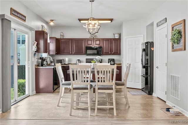 111 Aegean Ave, Amherst, NY 14228 - kitchen with black appliances, a chandelier, light countertops, decorative light fixtures, and dark brown cabinets