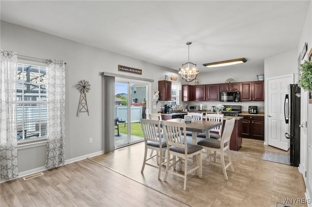 111 Aegean Ave, Amherst, NY 14228 - dining room featuring a chandelier and light wood-style flooring