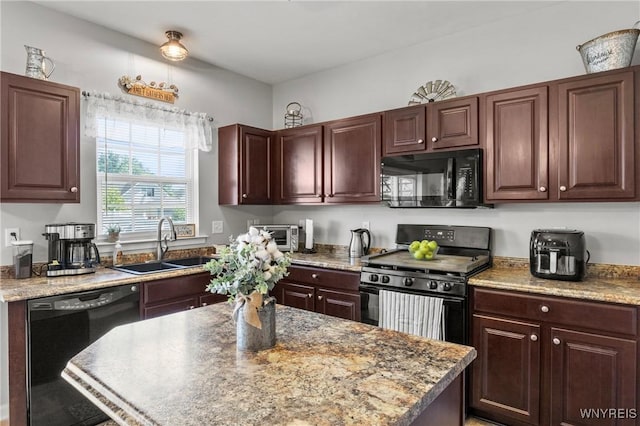 111 Aegean Ave, Amherst, NY 14228 - kitchen featuring black appliances, a center island, light countertops, and dark brown cabinetry