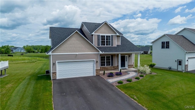 3427 Tall Tree Ln, Lysander, NY 13027 - traditional-style home featuring asphalt driveway, covered porch, an attached garage, and a front yard