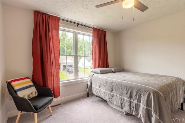 3427 Tall Tree Ln, Lysander, NY 13027 - bedroom featuring multiple windows, light colored carpet, a textured ceiling, and ceiling fan