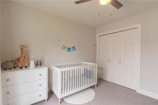 3427 Tall Tree Ln, Lysander, NY 13027 - bedroom featuring light carpet, a nursery area, a closet, and a ceiling fan