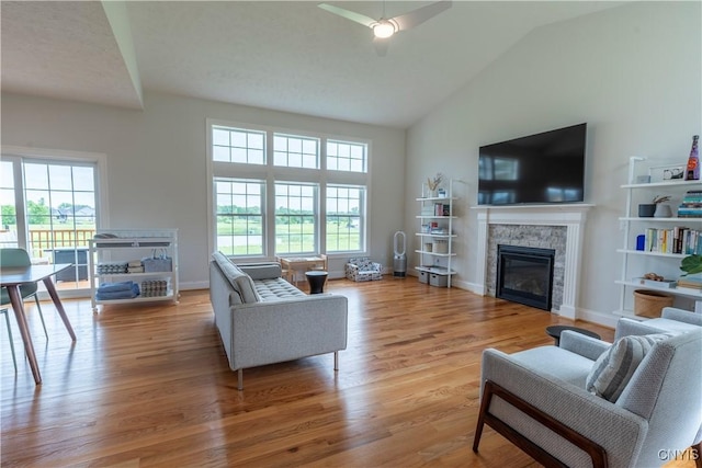 3427 Tall Tree Ln, Lysander, NY 13027 - living room featuring a fireplace, healthy amount of natural light, wood finished floors, a ceiling fan, and high vaulted ceiling