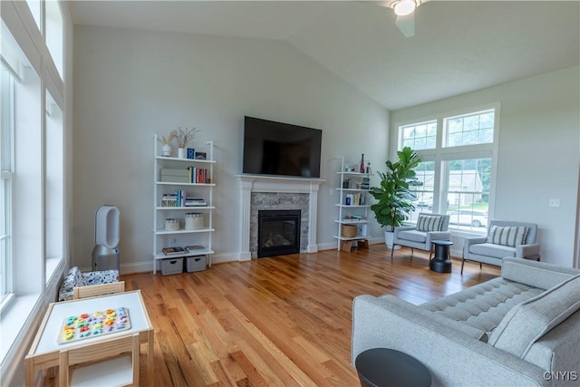 3427 Tall Tree Ln, Lysander, NY 13027 - living room with a fireplace, wood finished floors, vaulted ceiling, and a ceiling fan