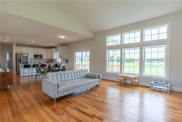 3427 Tall Tree Ln, Lysander, NY 13027 - living room featuring light wood finished floors, recessed lighting, and lofted ceiling