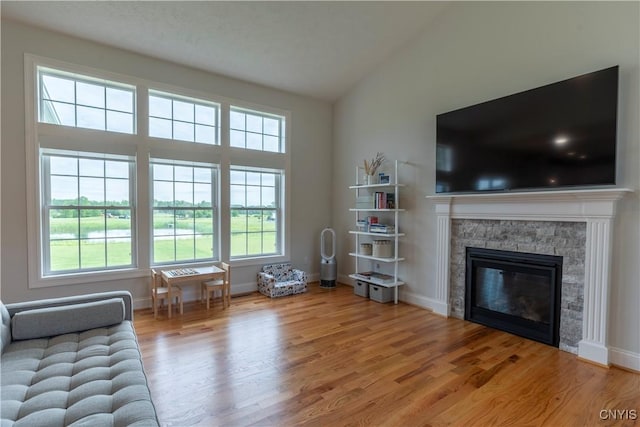 3427 Tall Tree Ln, Lysander, NY 13027 - living area with wood finished floors, a fireplace, and high vaulted ceiling