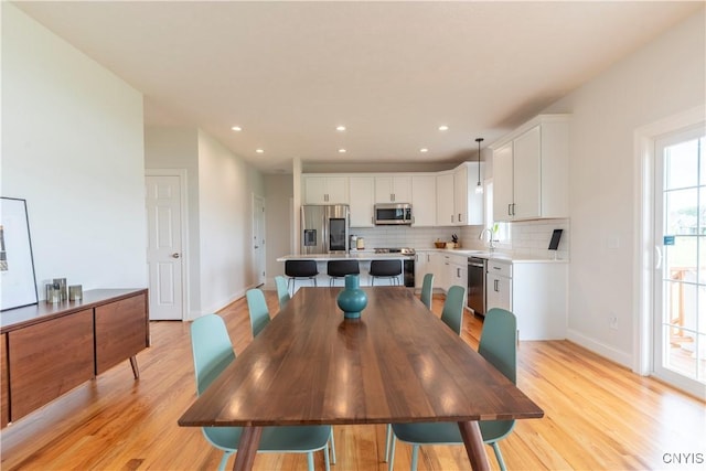 3427 Tall Tree Ln, Lysander, NY 13027 - dining room with light wood-type flooring and recessed lighting
