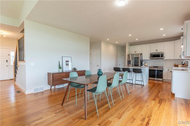3427 Tall Tree Ln, Lysander, NY 13027 - dining space featuring light wood-style flooring and recessed lighting