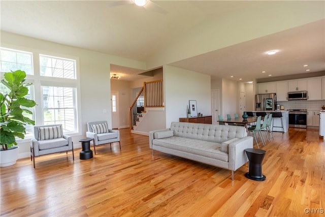 3427 Tall Tree Ln, Lysander, NY 13027 - living area with a ceiling fan, stairs, and light wood-style floors
