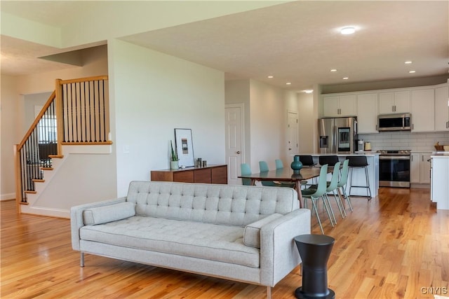 3427 Tall Tree Ln, Lysander, NY 13027 - living area featuring light wood-style flooring, stairway, and recessed lighting