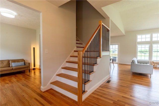 3427 Tall Tree Ln, Lysander, NY 13027 - staircase featuring wood finished floors and baseboards