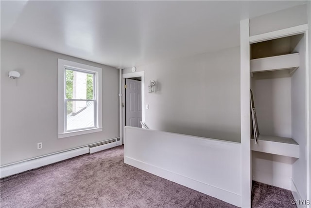 713 Parham St, Wilna, NY 13619 - carpeted empty room featuring a baseboard heating unit