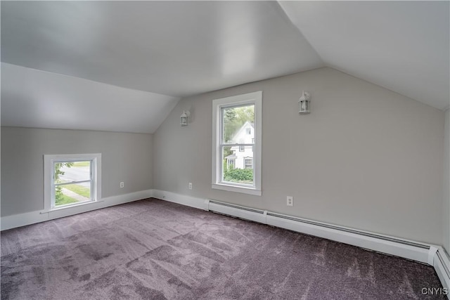 713 Parham St, Wilna, NY 13619 - additional living space featuring vaulted ceiling, a baseboard radiator, plenty of natural light, and carpet