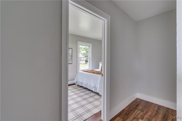 713 Parham St, Wilna, NY 13619 - unfurnished bedroom with dark wood-style floors and baseboard heating
