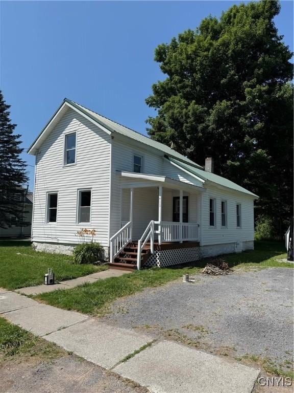 713 Parham St, Wilna, NY 13619 - view of front of house featuring covered porch and a chimney