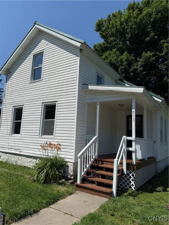 713 Parham St, Wilna, NY 13619 - view of front of property featuring a porch and a front lawn