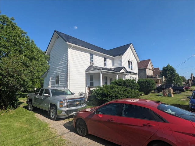 10 Mcclellan Ave, Mount Jewett Boro, PA 16740 - view of home's exterior with a yard, a metal roof, and a porch