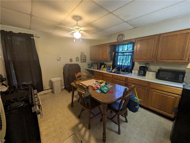 10 Mcclellan Ave, Mount Jewett Boro, PA 16740 - kitchen featuring light floors, a drop ceiling, black microwave, a ceiling fan, and brown cabinetry