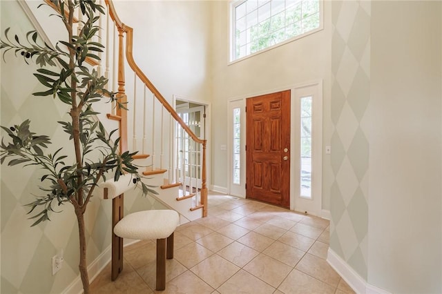 6915 Proximity Ln, Victor, NY 14564 - entrance foyer featuring healthy amount of natural light, stairs, light tile patterned floors, and a towering ceiling