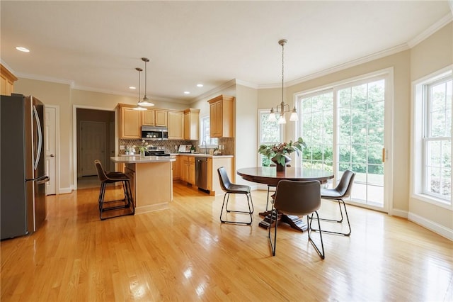 6915 Proximity Ln, Victor, NY 14564 - dining area featuring light wood-type flooring, ornamental molding, and recessed lighting