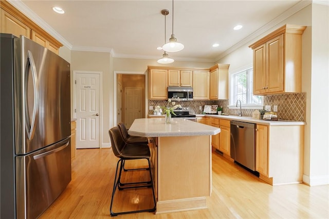 6915 Proximity Ln, Victor, NY 14564 - kitchen with stainless steel appliances, light countertops, light brown cabinets, light wood-style flooring, and ornamental molding