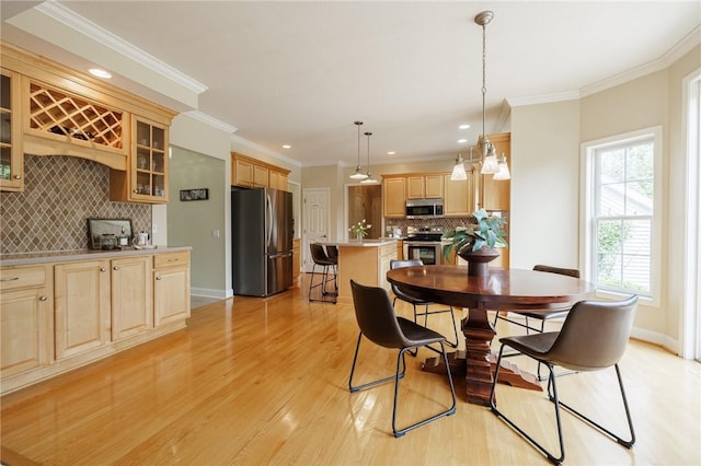 6915 Proximity Ln, Victor, NY 14564 - dining space with light wood finished floors, crown molding, and recessed lighting