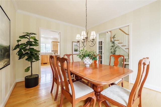 6915 Proximity Ln, Victor, NY 14564 - dining area with light wood finished floors, ornamental molding, a chandelier, stairway, and wallpapered walls