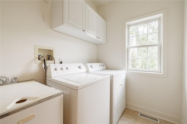 6915 Proximity Ln, Victor, NY 14564 - laundry room featuring cabinet space, separate washer and dryer, plenty of natural light, and light tile patterned flooring