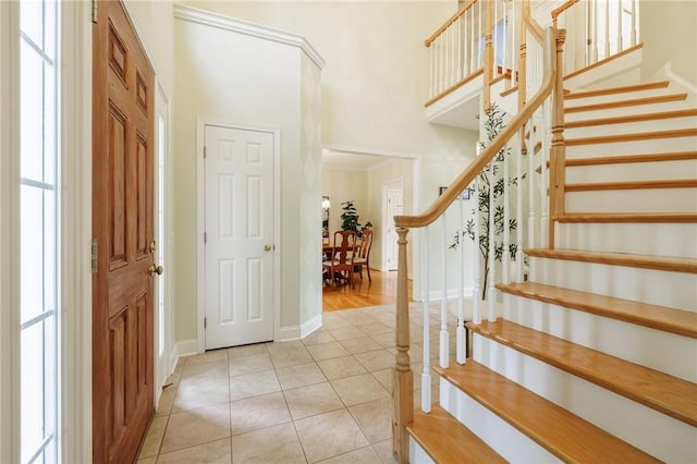 6915 Proximity Ln, Victor, NY 14564 - entrance foyer with stairway, a high ceiling, and light tile patterned floors