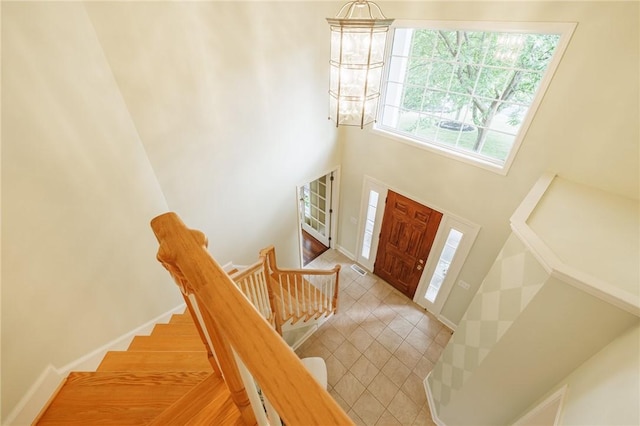 6915 Proximity Ln, Victor, NY 14564 - foyer featuring a high ceiling, light tile patterned floors, stairs, and a chandelier