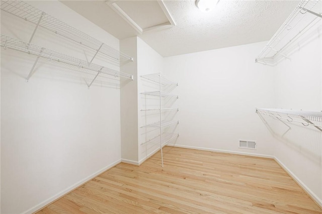 6915 Proximity Ln, Victor, NY 14564 - spacious closet featuring wood finished floors and attic access