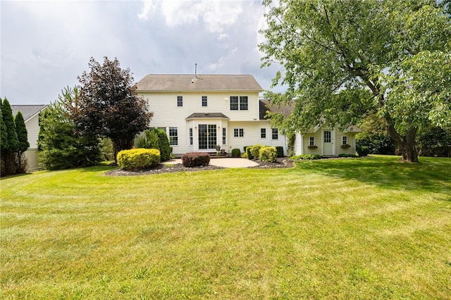 6915 Proximity Ln, Victor, NY 14564 - rear view of house with a lawn and a patio area