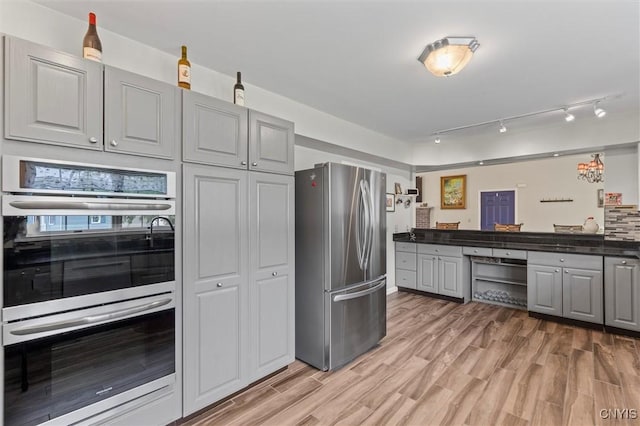 331 Hickory Ln, Hastings, NY 13036 - kitchen with appliances with stainless steel finishes, gray cabinets, dark countertops, and light wood finished floors