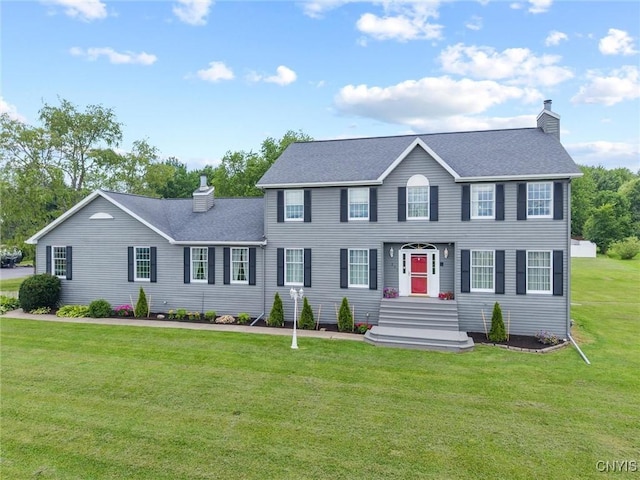 331 Hickory Ln, Hastings, NY 13036 - colonial-style house with a chimney, a front lawn, and roof with shingles