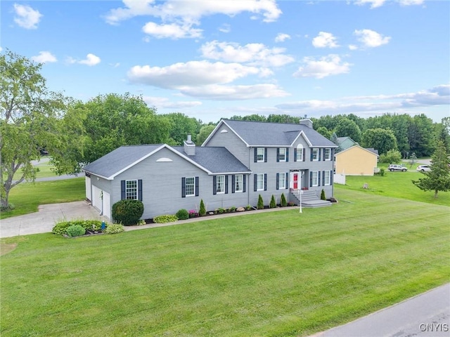 331 Hickory Ln, Hastings, NY 13036 - colonial house with driveway, a chimney, a front lawn, and a garage