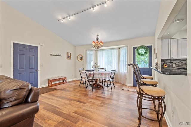 331 Hickory Ln, Hastings, NY 13036 - dining area with rail lighting, lofted ceiling, a chandelier, and light wood-style flooring